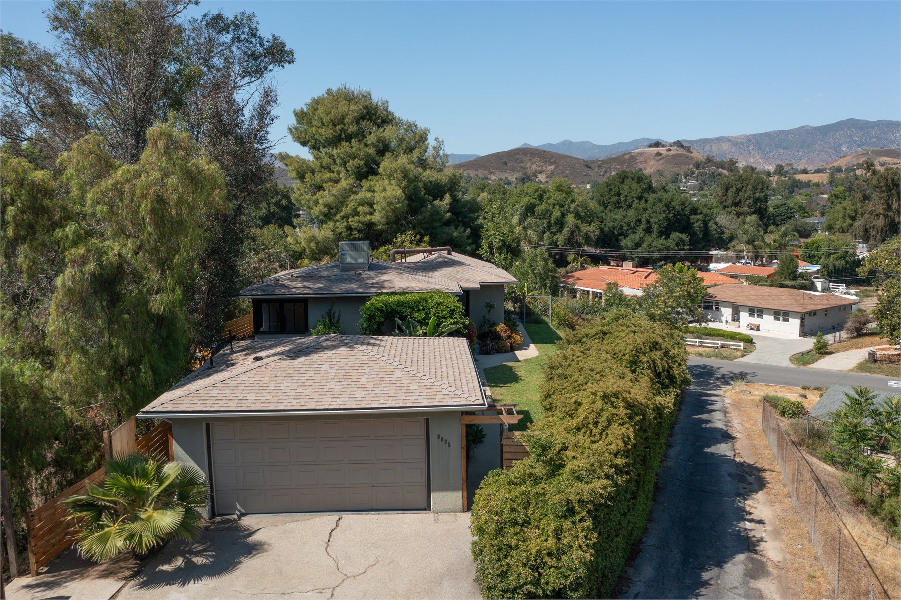 Residential aerial view showing property setting and surrounding hills