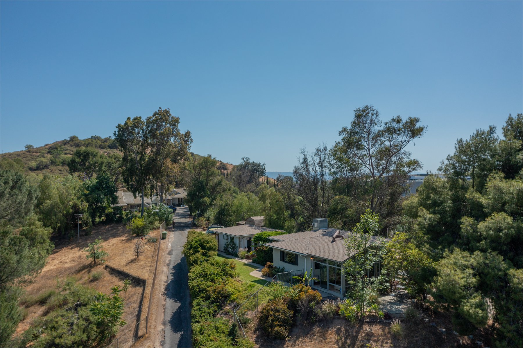 Drone image showing hillside residential property setting