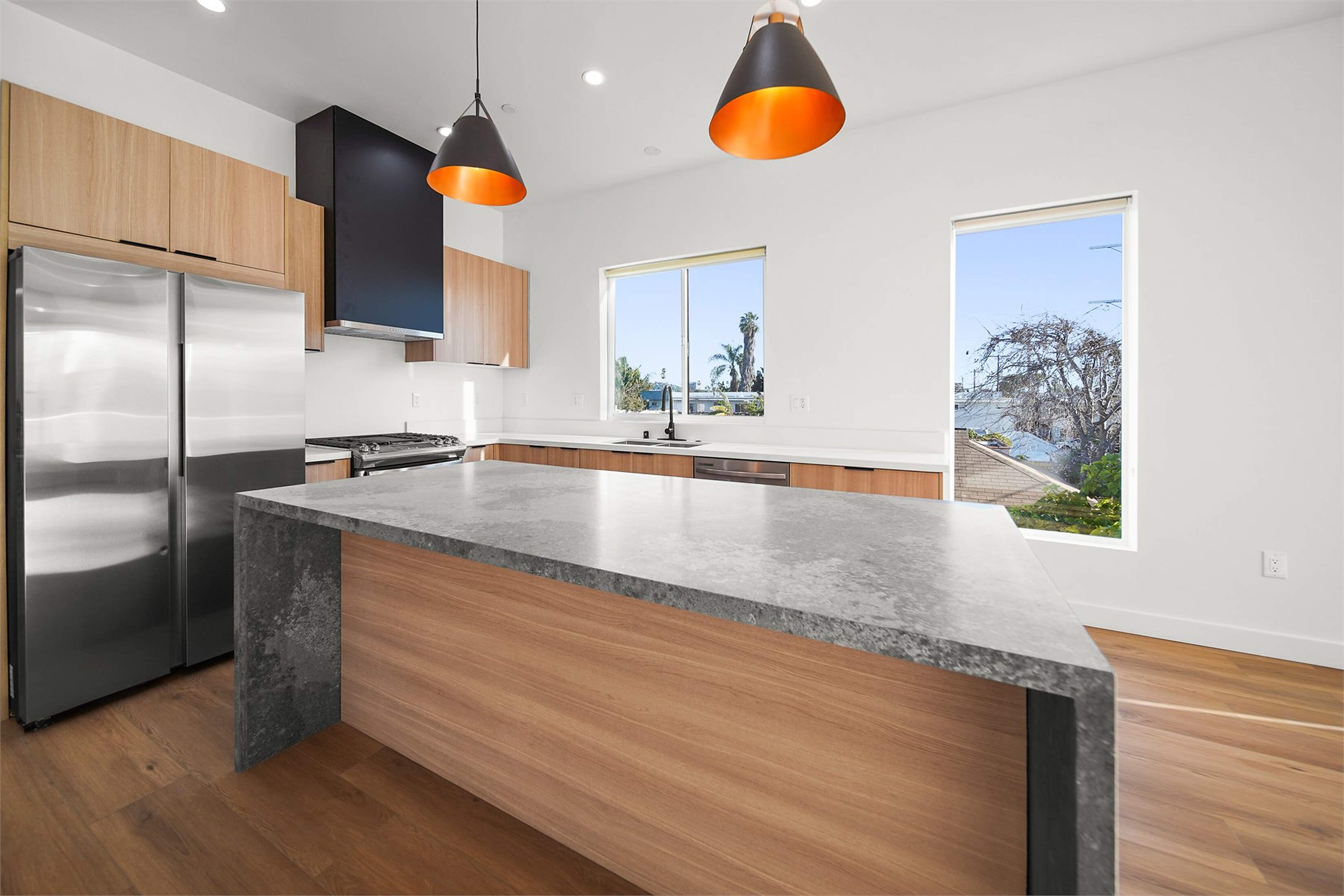 Modern HDR kitchen photo with bright windows, clean counters, and balanced interior light