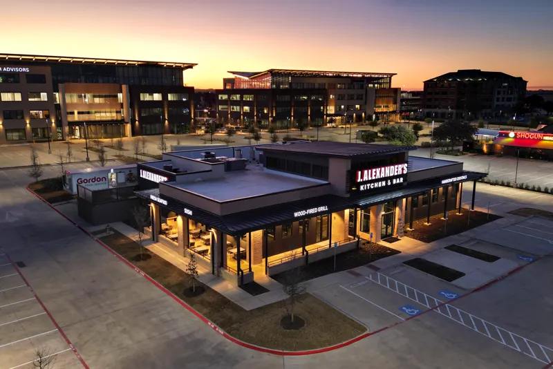 Restaurant and surrounding buildings photographed from the air at dusk