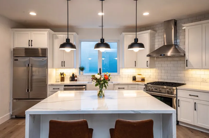 Bright residential kitchen island with pendant lights