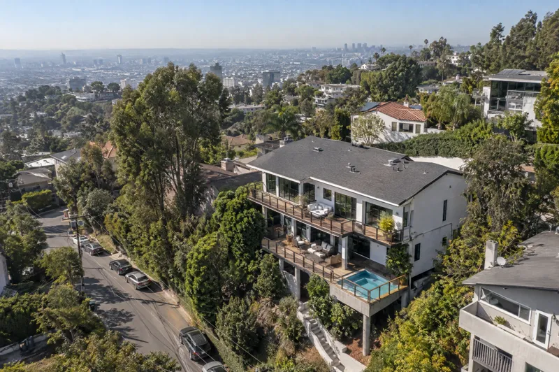 Daytime residential drone photo: hillside perch