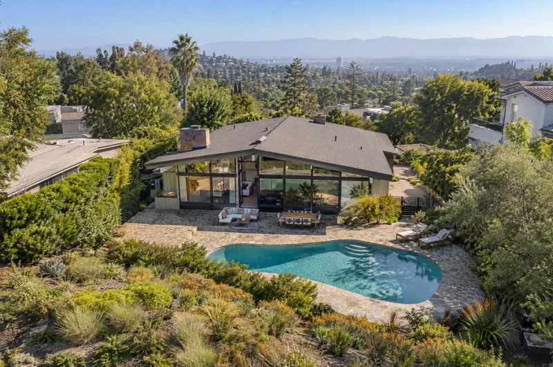 Daytime residential drone photo: mid-century rear