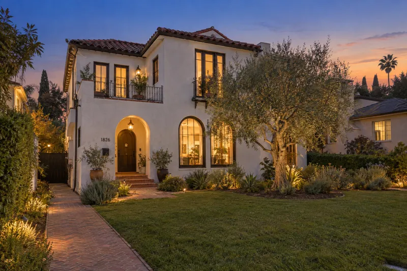 Spanish Revival home photographed at twilight from a ground-level angle