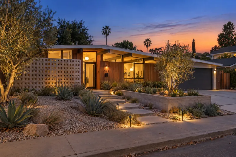 Mid-Century Modern home photographed at twilight from a ground-level angle