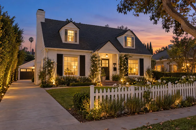Cape Cod home photographed at twilight from a ground-level angle