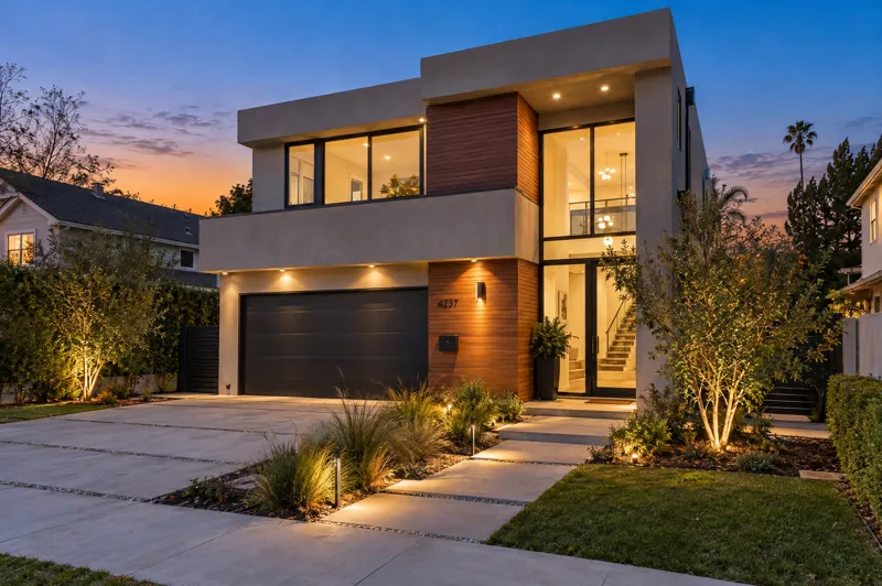 Contemporary home photographed at twilight from a ground-level angle