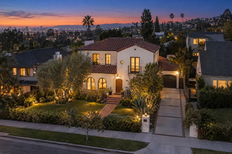 Spanish Revival home photographed at twilight from an aerial drone angle