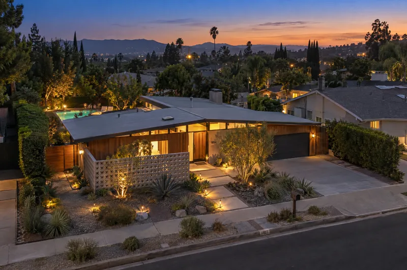 Mid-Century Modern home photographed at twilight from an aerial drone angle