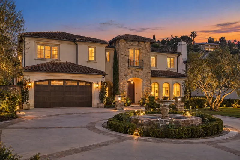 Mediterranean home photographed at twilight from a ground-level angle
