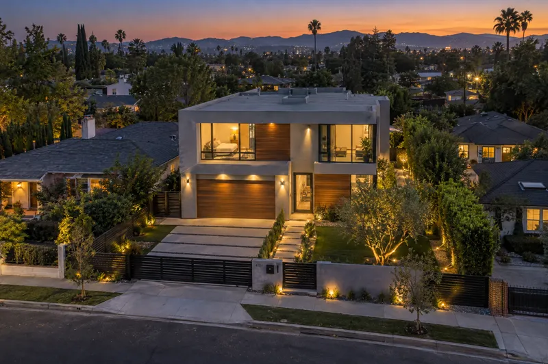 Contemporary home photographed at twilight from an aerial drone angle