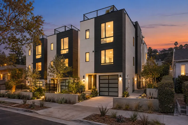 Small-Lot Townhomes home photographed at twilight from a ground-level angle